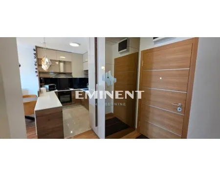 Modern kitchen with a breakfast bar and fitted appliances. - image 10