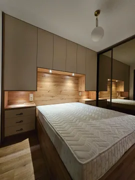 Modern bedroom with built-in wardrobes and a double bed. - image 7