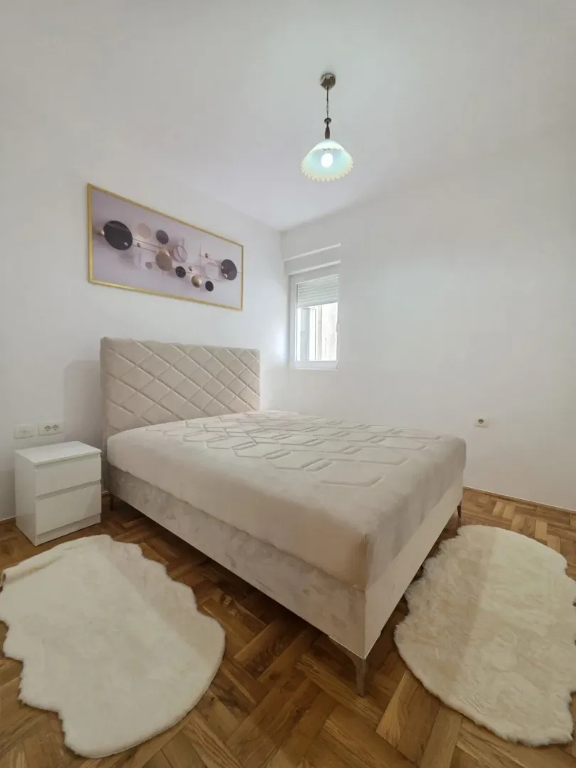 Bright and tidy bedroom with a double bed.