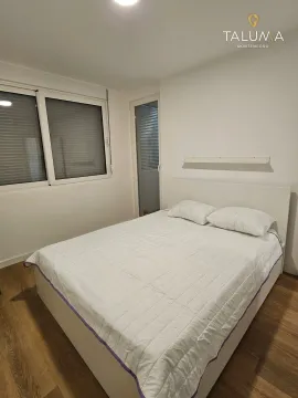 Bedroom with a double bed, window, and white walls. - image 4