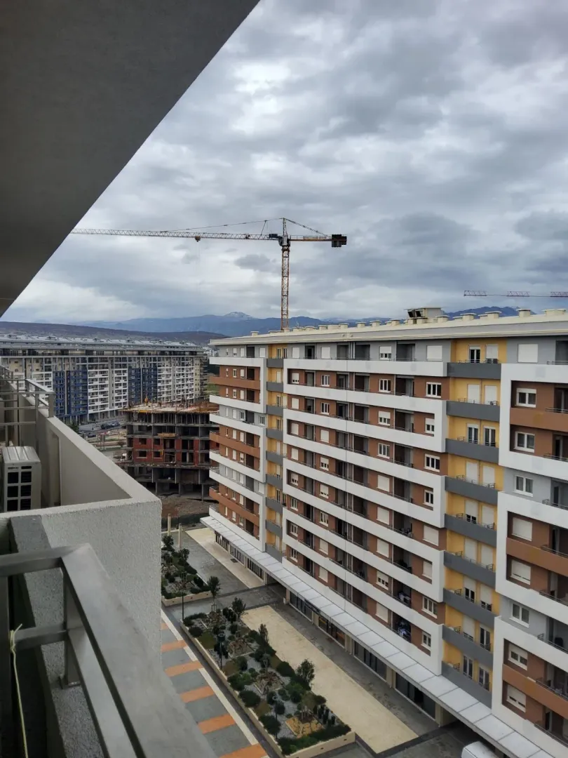 View from the balcony overlooking surrounding residential buildings and a construction site.