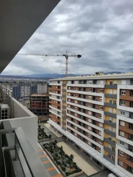 View from the balcony overlooking surrounding residential buildings and a construction site. - image 9