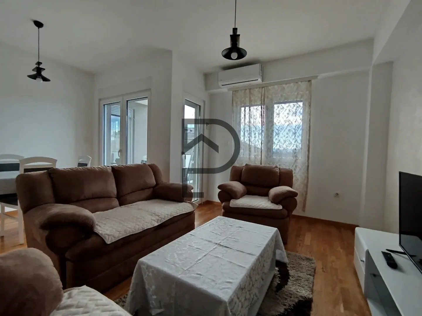 Bright living room with a sofa set and dining area.