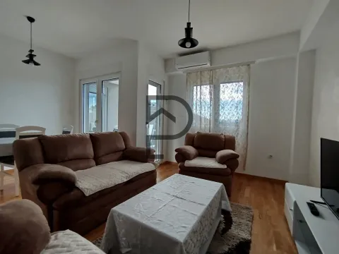 Bright living room with a sofa set and dining area. - image 2