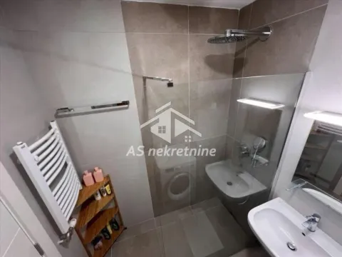 Modern bathroom with a shower cabin and a sink. - image 10