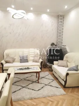 Living room with seating furniture, coffee table, and fireplace. - image 2