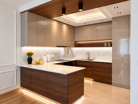 Modern kitchen with wooden elements, marble countertops, and recessed lighting. - image 2