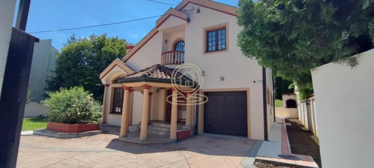 Front view of the house with yard, entrance, and garage.