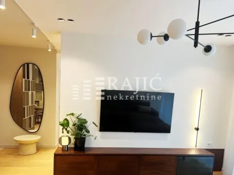Modern living room with TV and decorative lighting. - image 3