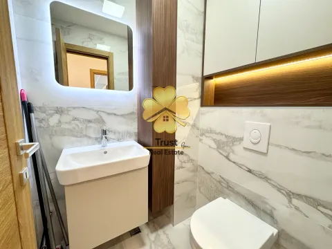 Modern bathroom with a sink, mirror, and toilet. - image 13