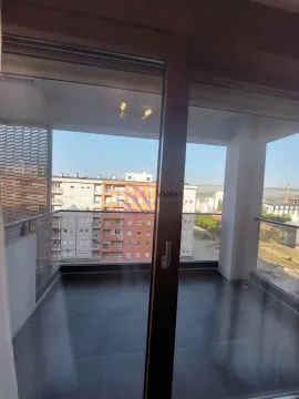 View through the balcony door to the terrace and surrounding buildings. - image 6