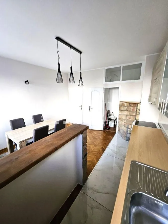 Kitchen with a breakfast bar and dining area.