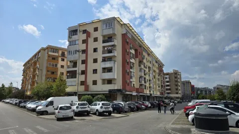 Exterior view of the apartment building and parking lot in front. - image 2