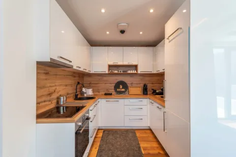 Modern white kitchen with wooden details. - image 15