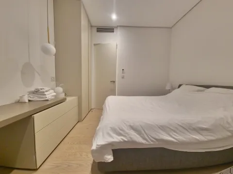 Modern bedroom with a double bed, built-in wardrobe and chest of drawers. - image 16
