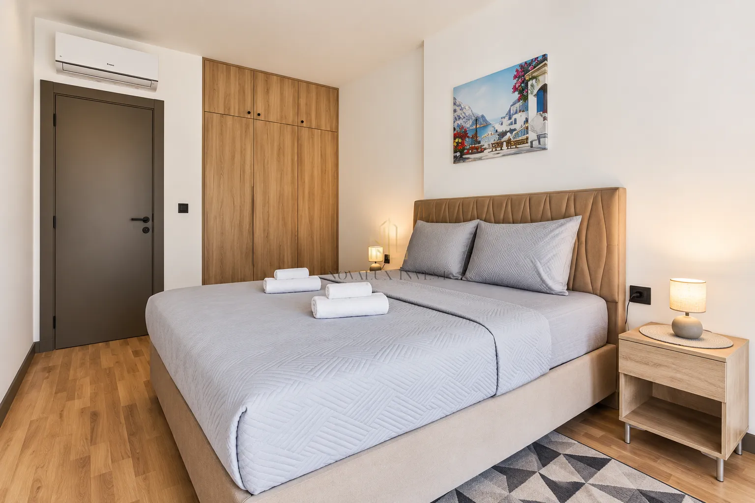 Modern bedroom with a double bed, built-in wardrobe, and nightstand.