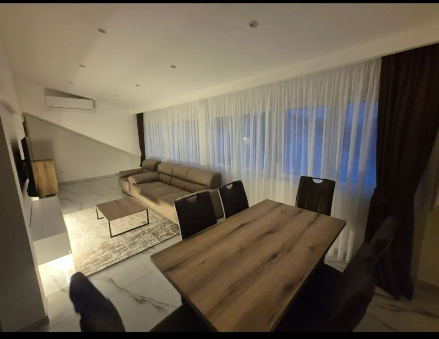 Living room with a sofa set and a dining table.