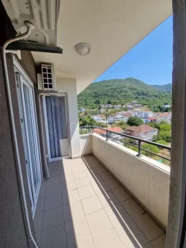 Covered balcony with a view of the settlement and surrounding hills. - image 6