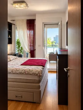 View from the hallway into a furnished bedroom with access to the terrace. - image 3