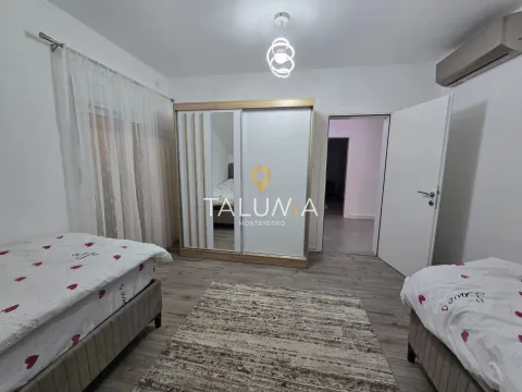 Furnished bedroom with two single beds, a large wardrobe, and a rug. - image 6