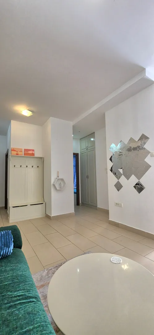 View of a bright living room with a sofa and hallway area.