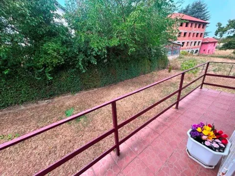 View from the tiled terrace onto the green yard and surrounding buildings. - image 3