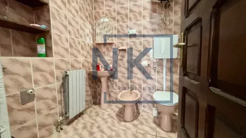 Tiled bathroom with a toilet, washbasin, and bidet. - image 3