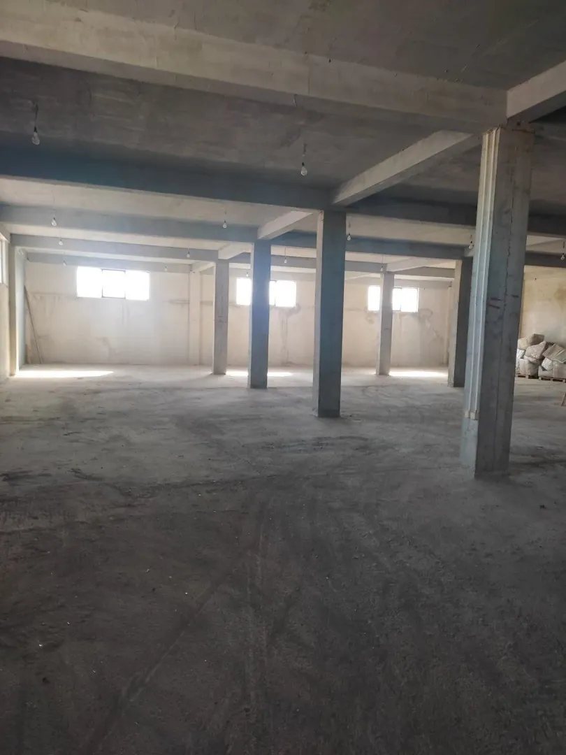 Large unfinished space with concrete pillars.