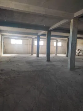 Large unfinished space with concrete pillars. - image 3