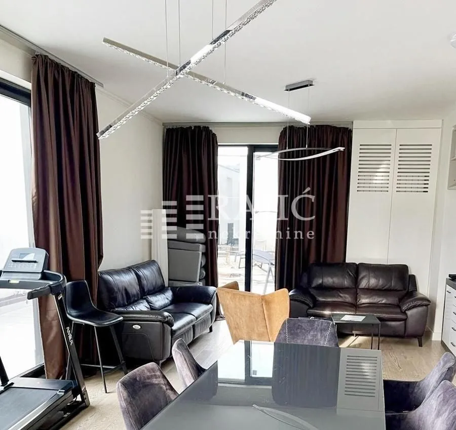 Living room with a sofa set and a dining table.