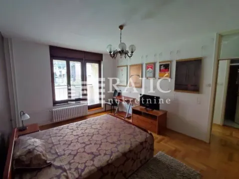 Furnished bedroom with a double bed, TV cabinet, and access to the terrace. - image 4