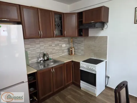Kitchen with dark wooden units, sink, and cooker. - image 8