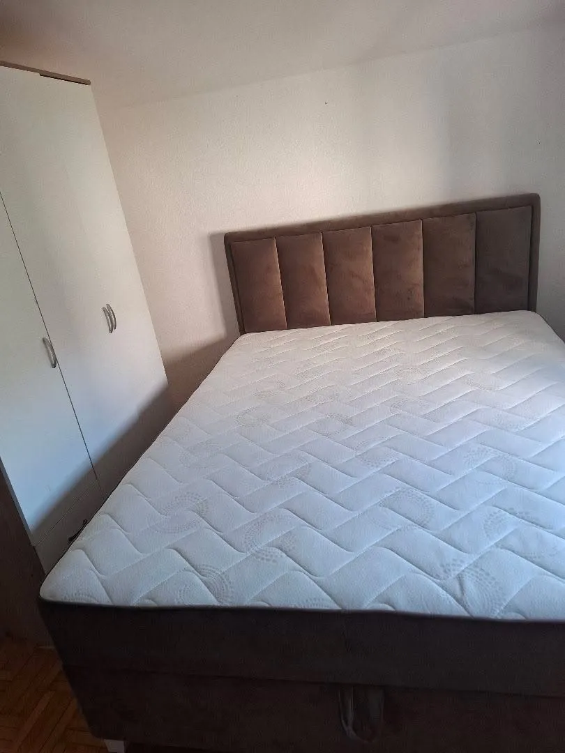 Bedroom with a double bed and a wardrobe.