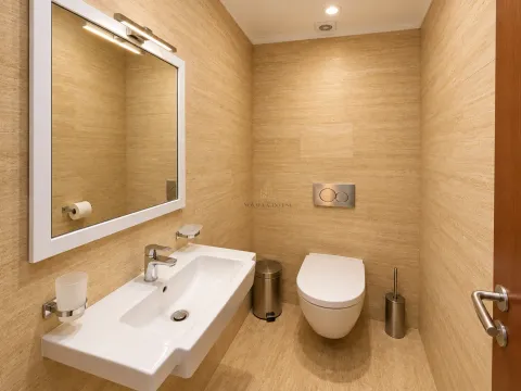 Modernly equipped bathroom with a washbasin and a wall-hung toilet. - image 12