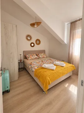 Furnished bedroom with a double bed, wardrobe, and sloping ceiling. - image 5