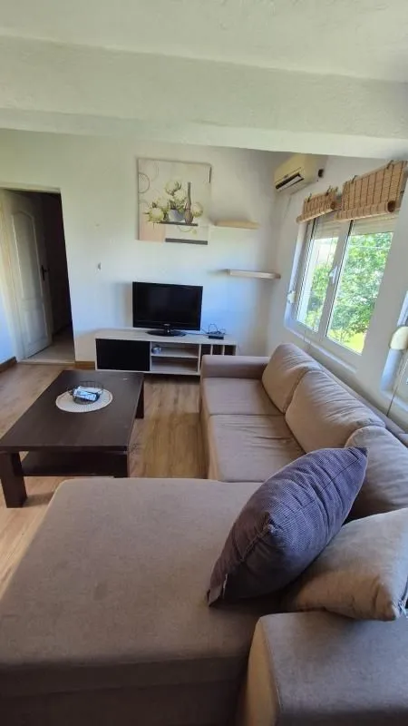 Living room with a sectional sofa, TV, and coffee table.
