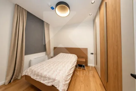 Furnished bedroom with a double bed, wooden flooring, and a built-in wardrobe. - image 18