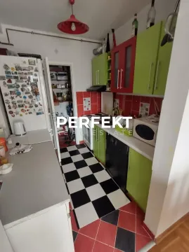 Kitchen with colorful cabinets and black and white floor tiles. - image 3