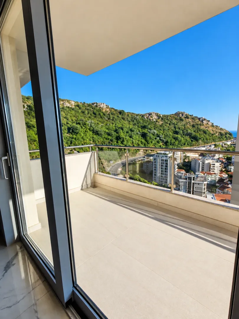 Spacious balcony with a view of the hills and town.