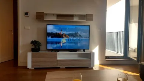 Living room with a TV and access to the terrace. - image 16