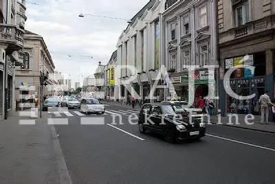 View of a city street and building facades with traffic.