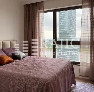 Bedroom with a double bed and a large window with a city view. - image 7