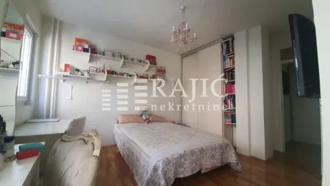 Furnished bedroom with a double bed, wardrobe, and desk. - image 9