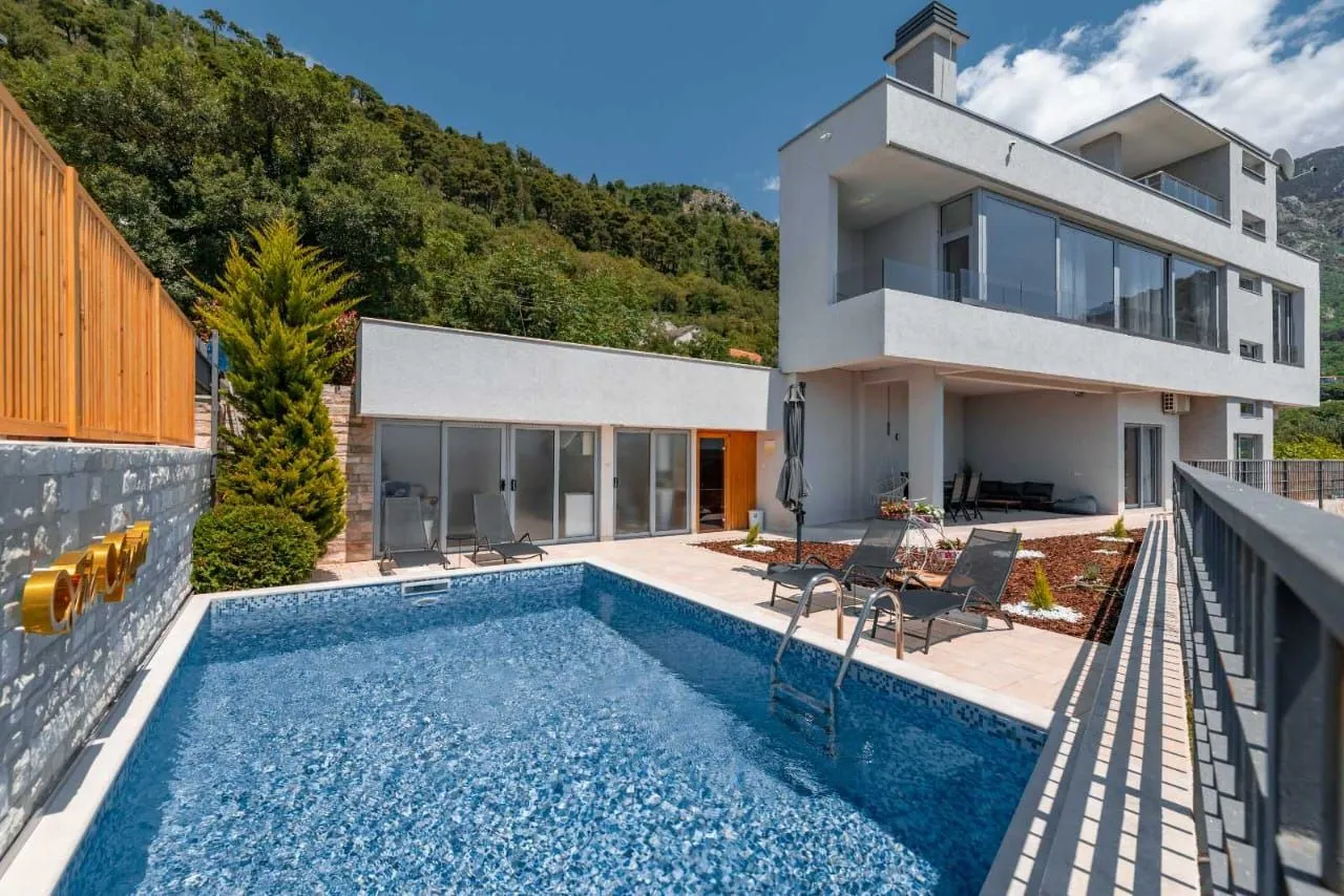 Exterior of the house with a swimming pool and landscaped yard.