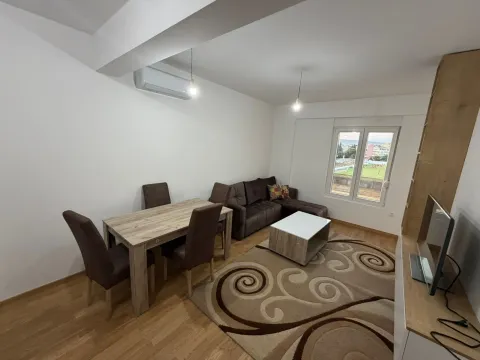 Living room with a dining table and a sectional sofa. - image 2