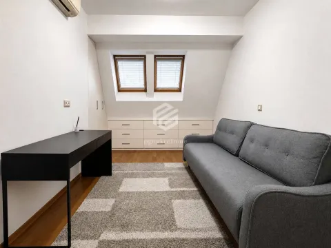Living room with a grey sofa, desk, and roof windows. - image 9