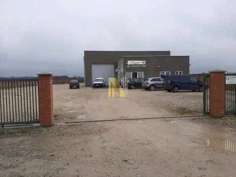 Exterior of a commercial building with a yard and parking area. - image 2