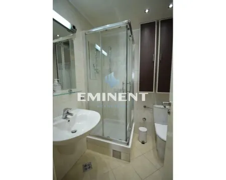 Bathroom equipped with a shower cabin, washbasin, and toilet. - image 18