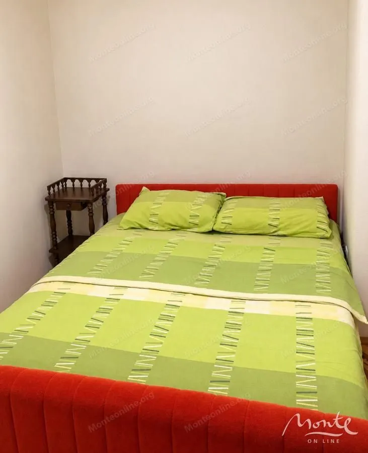 Smaller bedroom with a double bed and a bedside table.