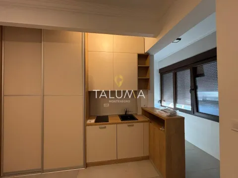 Small kitchen with light-colored cabinetry and a built-in wardrobe. - image 5